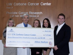 General Manager Skip Harless and Hilton Madison associates present a check to the University of  Wisconsin Carbone Cancer Center